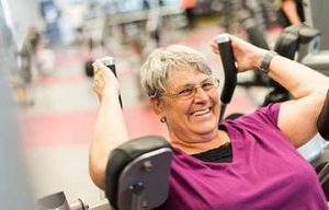 Senior woman using fitness equipment at the YMCA