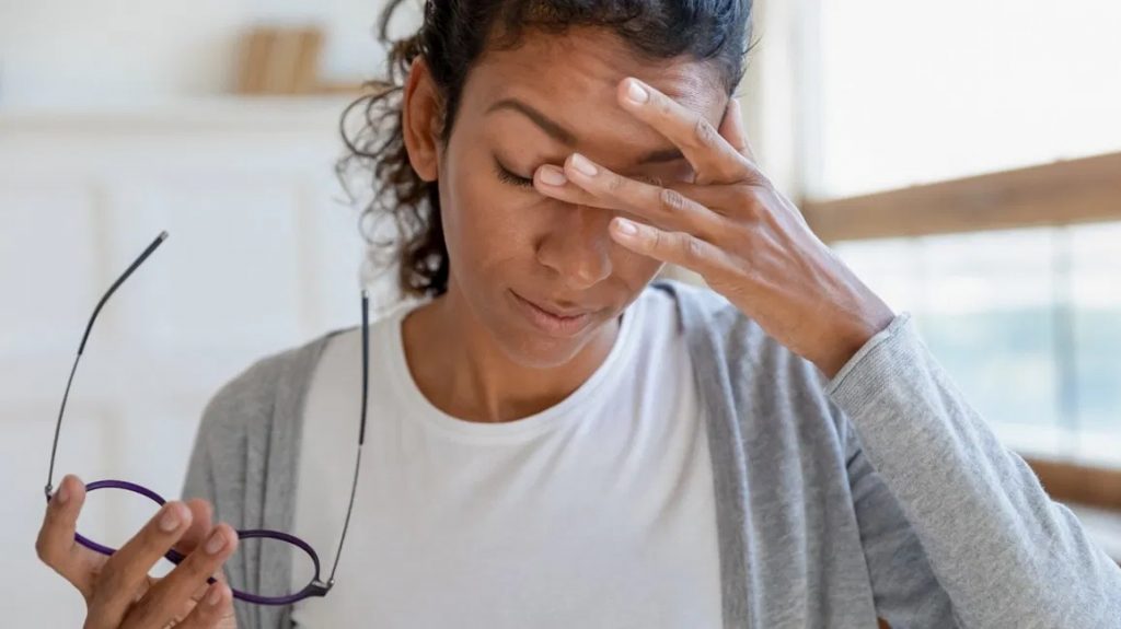 Woman rubbing her eyes, tired