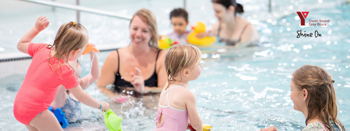 Group of families swimming in indoor pool